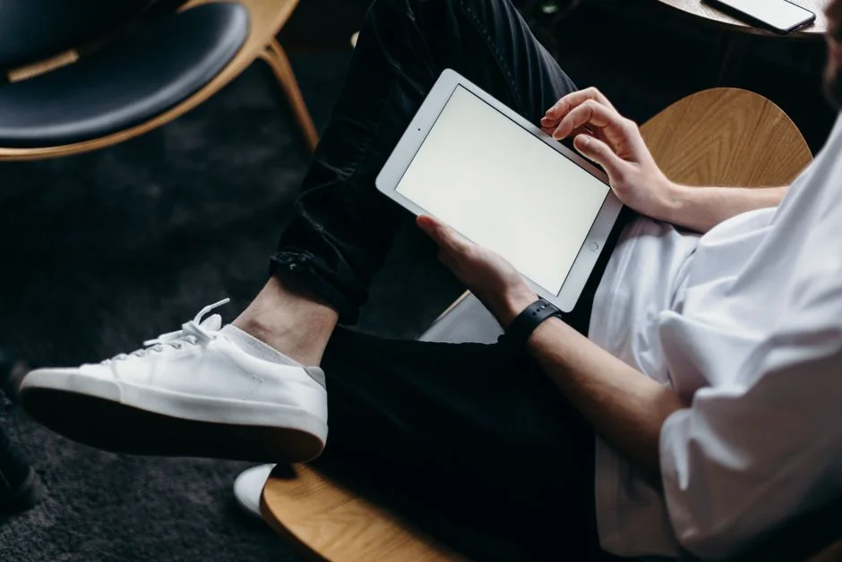 A person using a laptop to browse stock photo websites. Freelancing work in a cozy setting.